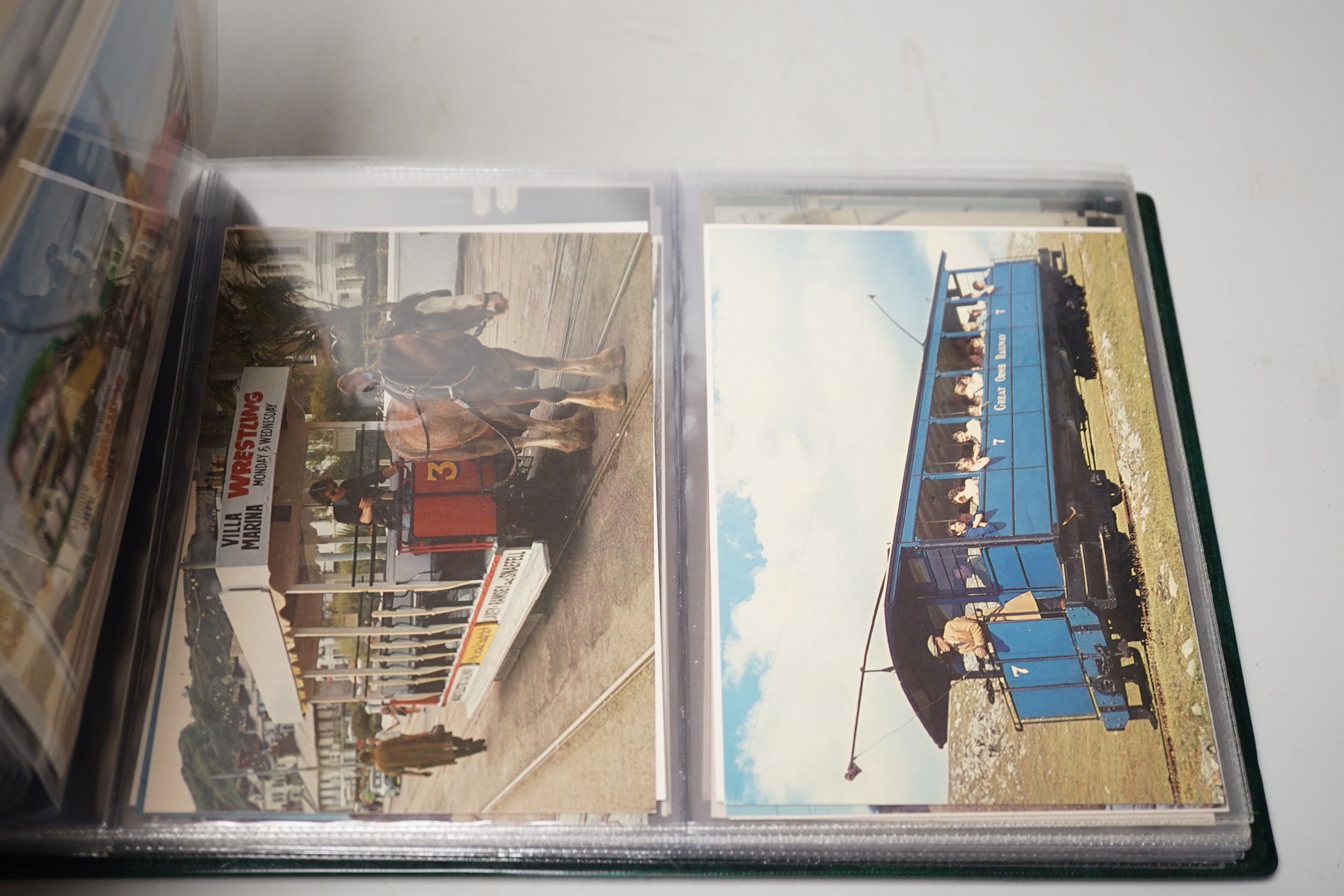 Postcards in three albums, to include themes, transport, theatre and topographical